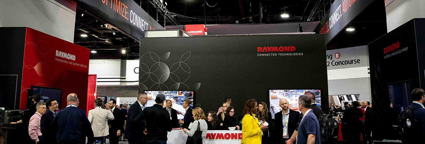 People standing at a trade show booth