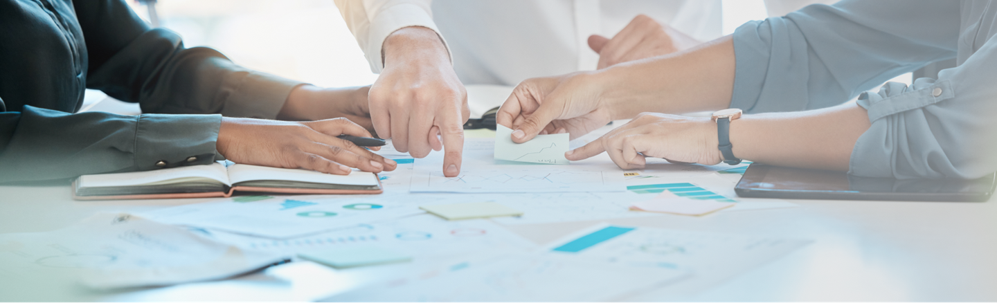 Researchers pointing to data on a table